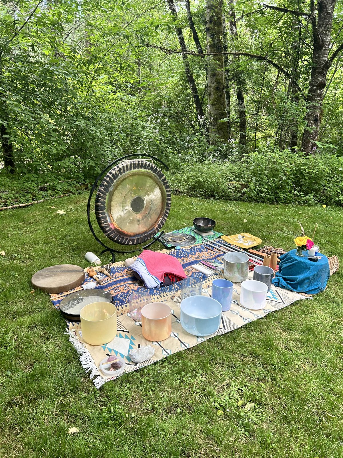 Sound ceremony setup with gong and crystal singing bowls on the lawn